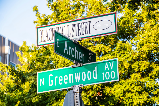 06_01_2020 Tulsa USA  Black Wall Street and N Greenwood Avenue  and Archer street signs - closeup - in Tulsa Oklahoma with bokeh background