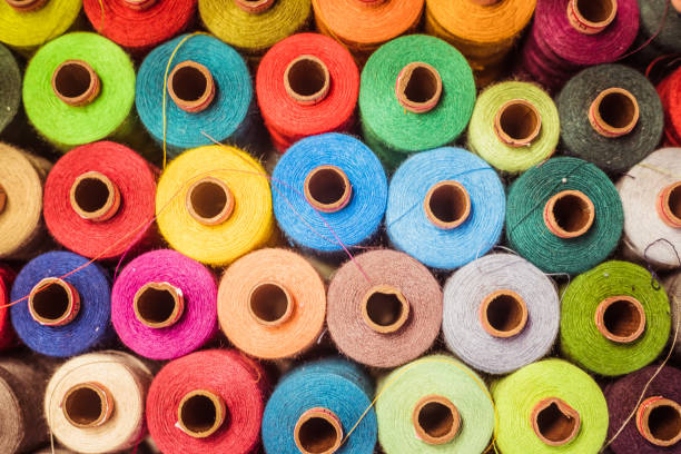 istock Threads in a tailor textile fabric: colorful cotton threads, birds eye perspective 1249614352