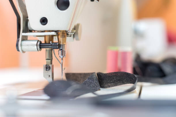 istock Sewing in a tailor workshop: Close up picture of sewing needle 1249614435