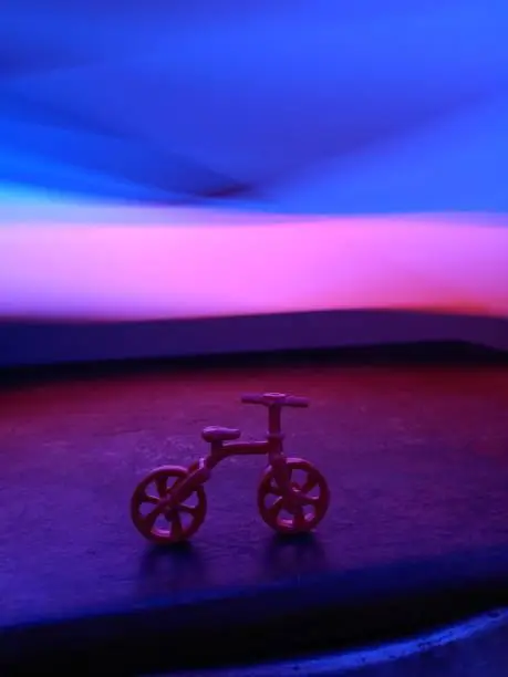 Photo of Red Toy bicycle with light painting.