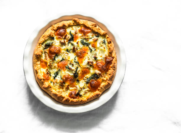 istock Canned tuna, mozzarella, spinach, potatoes rustic pie on a light background, top view 1249616802