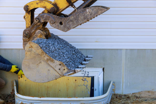 Moving gravel scoop building materials window well for basement construction new residential home