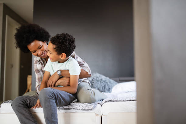istock Happy mother playing, having fun, hugging with her son at home 1249622056