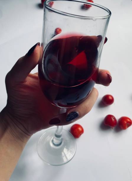 a glass of cherries on a black and white background