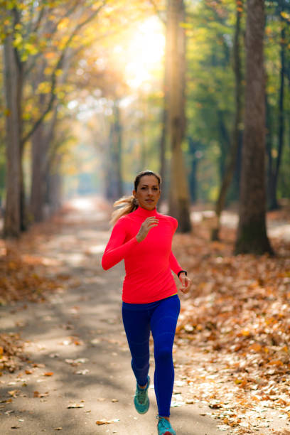istock Woman Jogging Outdoors in Park 1249623262