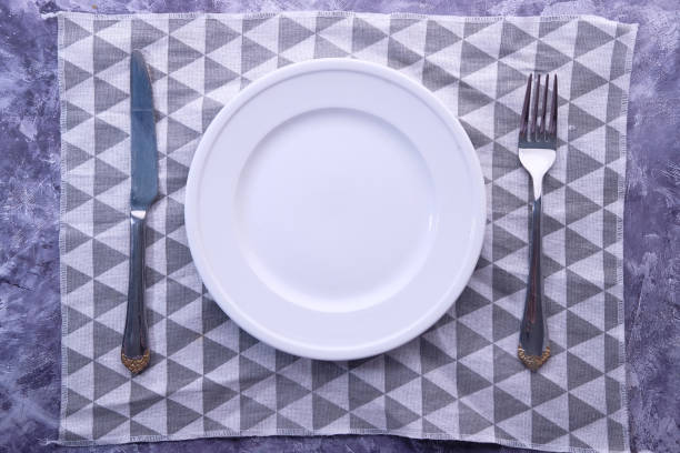 istock Clean plate and cutlery on wooden background 1249624078
