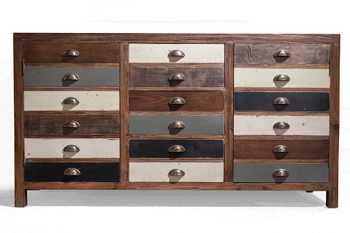 Vintage wooden chest of drawers with different handles