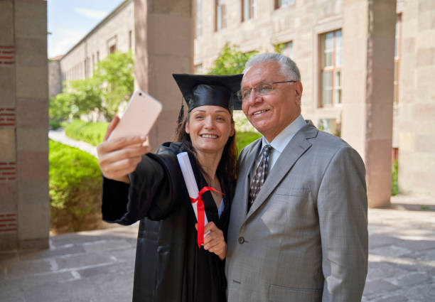 istock Young university graduate and her father taking selfie 1249627046