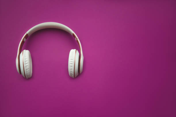 istock Red wireless headphone on magenta background. top view. space for text. 1249627492