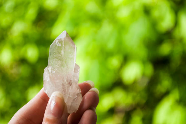 istock Quartz. Natural crystal without processing on a green background. Place for text 1249628341