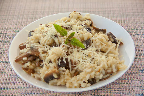 istock Tasty appetizing risotto on  white plate on  wooden table 1249628727