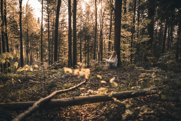 istock Young woman in PPE suit escapes into the forest 1249629984