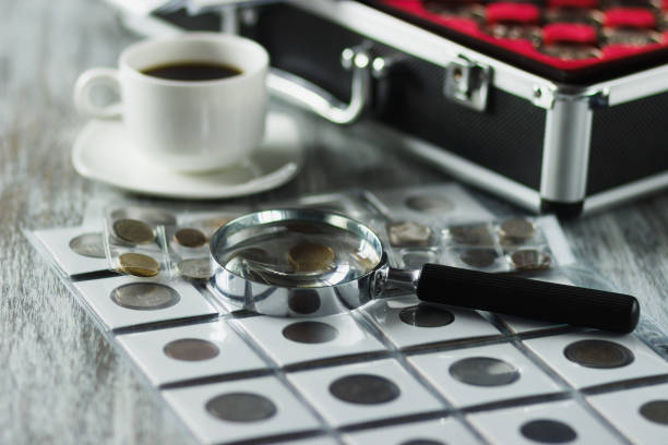 istock Different old coins and magnifying glass, Soft focus background 1249630060