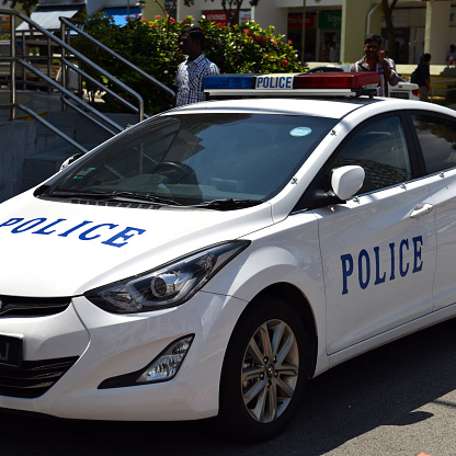 White policecar on a sunny day in Singapore