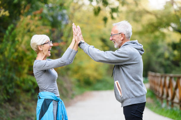 istock Active senior couple exercising in the park having fun laughing 1249633015