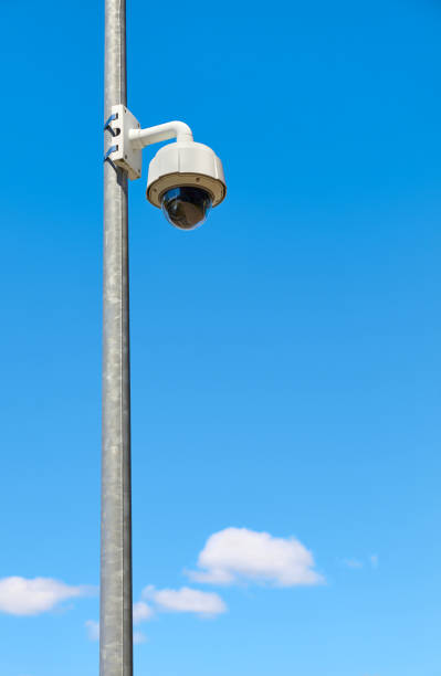 istock CCTV camera against the blue sky. 1249633056
