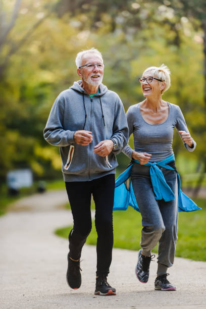 Smiling senior couple jogging in the park