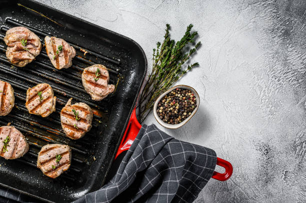 istock Tender boneless grilled pork chops. steak tenderloin. gray background. Top view. Copy space 1249634651