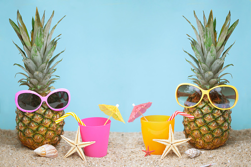 Pineapple in sunglasses at beach party