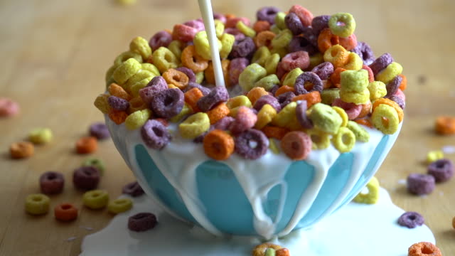 Milk Pouring Into Colourful Bowl of Cereal Timelapse