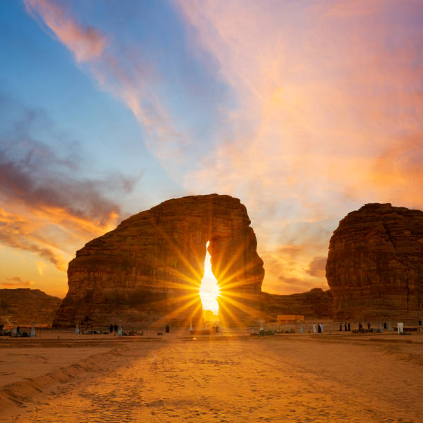 Elephant rock outcrop geological formation at Sunset near Al Ula, Saudi Arabia Al Ula, January 2, 2020. Cafes, food outlets and live entertainment is set up around Al Ula's iconic Elephant Rock during the Winter at Tantora Festival in January 2020. Al-ʿUla is a governorate of the Medina Region, and a city in north-western Saudi Arabia. al madinah stock pictures, royalty-free photos & images