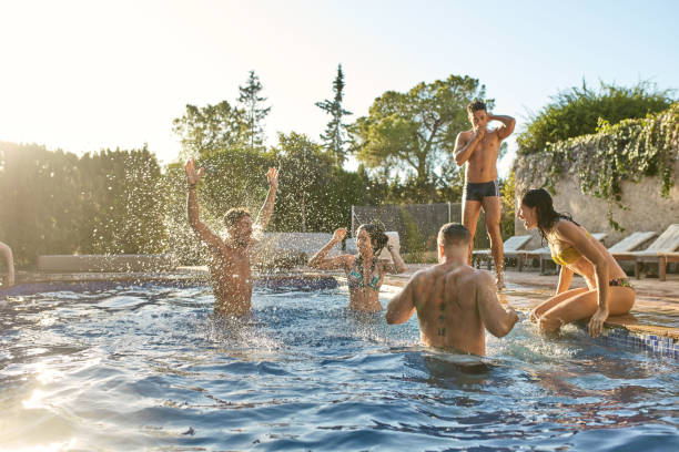 istock Relaxed Friends Enjoying Weekend Fun in Swimming Pool 1249641753