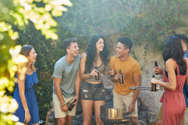 istock Relaxed Friends Laughing, Drinking Beer, and Barbecuing 1249641768
