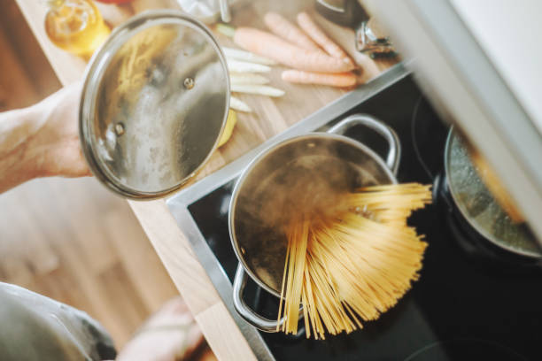 istock Man cooking fresh food at home 1249641913