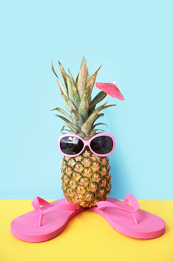 Pineapple in sunglasses and flip flops