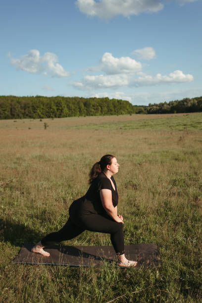 istock Overweight woman stretching legs doing exercises 1249645324