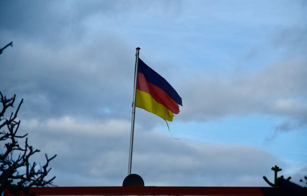 istock German flags with blue sky background unique photo 1249645396