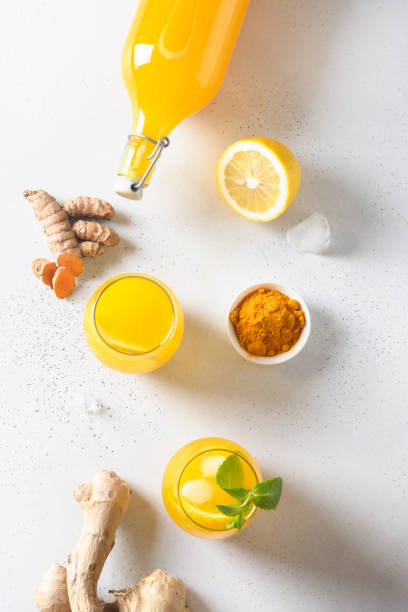 istock Jamu beverage of turmeric, ginger, lemon on white background. Vertical. View from above. 1249645573