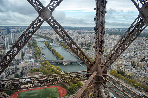 Paris, France - October 2019: Completed in 1889, the Eiffel Tower is the iconic symbol of Paris. View from the elevator to the summit looking down the Seine River toward the Pont de Bir-Hakeim.