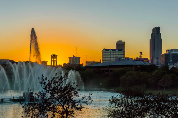 istock Sunset with skyline silhouette and fountain 1249652015