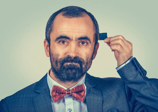 istock man wearing elegant jacket and red bow tie holding Micro SD card near his head 1249657776