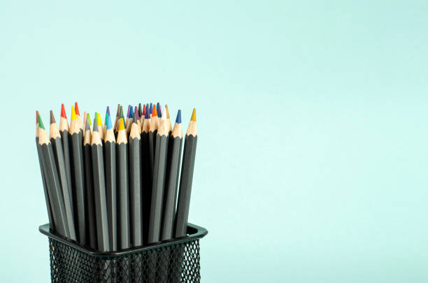istock Colored pencils in a case on a blue background. 1249658539