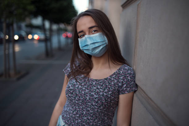 istock Beautiful young woman wearing protective mask 1249659481