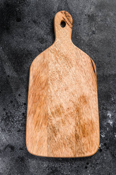 istock Wooden cutting Board. Black background. Top view. Copy space 1249659496