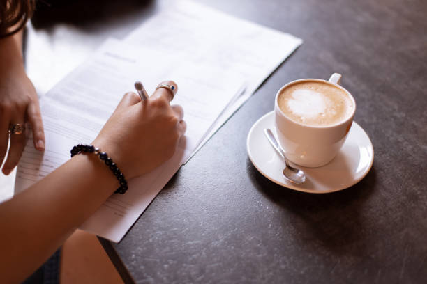 istock female hand sign model release document in cafe soft focus concept picture with wooden table and cup of coffee 1249660861