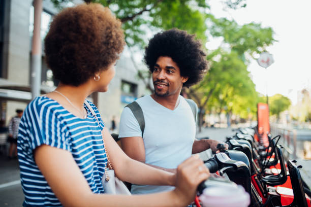 istock Couple sitting on rent-a-bikes and talking 1249667443