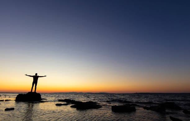 istock Man with arms outstretched celebrate mountains sunrise 1249667762