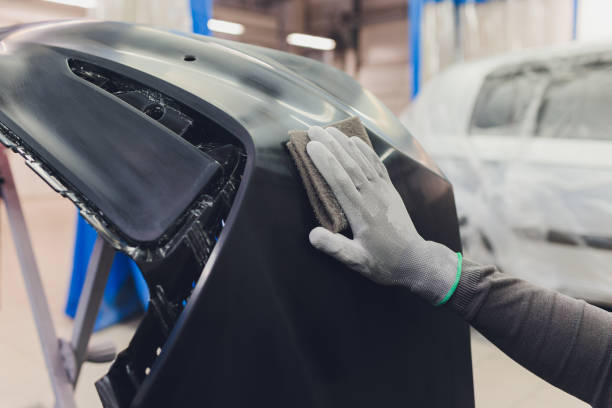 istock Auto mechanic preparing the car for paint job by applying polish with the power buffer machine 1249669686