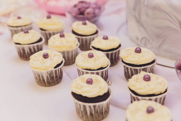 istock Cupcake packaging, delivery box, vanilla cupcakes with pink and white cream, selective focus, close up. 1249670817