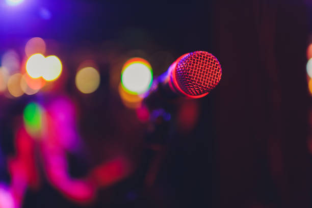 istock Microphone on stage in club with background. 1249670835