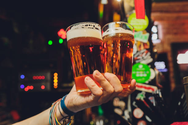 istock Woman holding three glasses of beer bartender. 1249670842