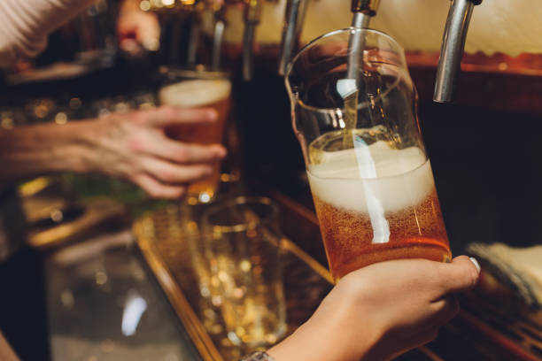 istock Barkeeper pulling a pint of beer behind the bar. 1249670847