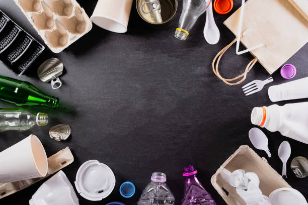 istock Top view of Different garbage materials with recycling symbol on black background. Recycle, World Environment Day, go green and Eco concept 1249674772