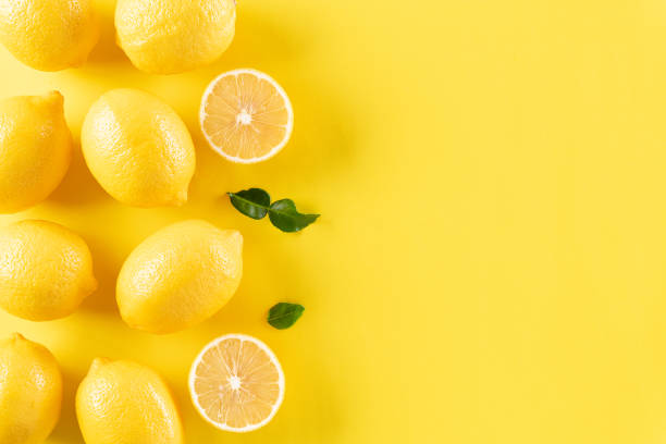 istock Summer composition made from oranges, lemon and green leaves on pastel yellow background. Fruit minimal concept. Flat lay, top view, copy space. 1249674808