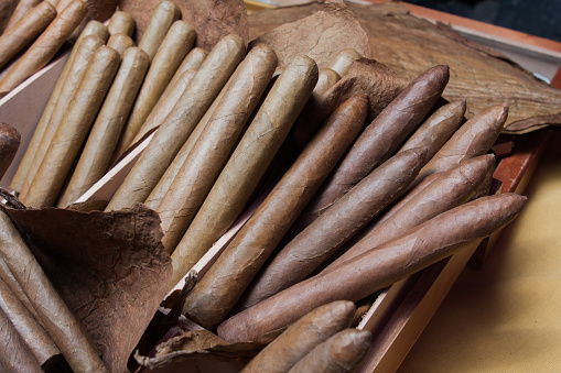 Stock of hand-made cigars on table