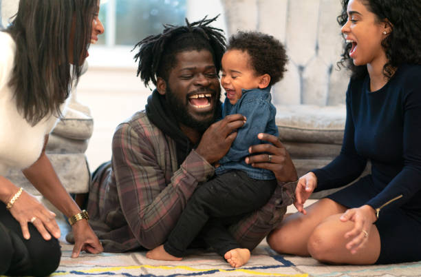 istock Toddler boy laughing with mixed race family 1249681496